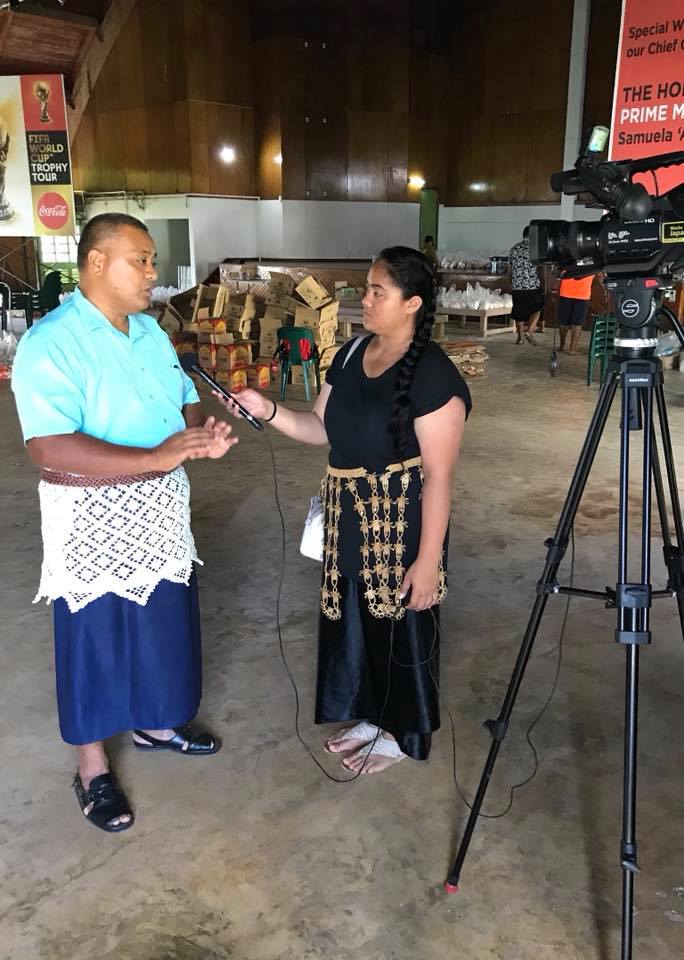 Pastor Saia Vea is interviewed by a TV reporter.