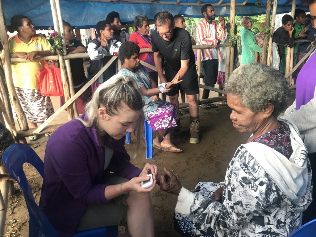 PNG lady receives blood glucose test from nurse