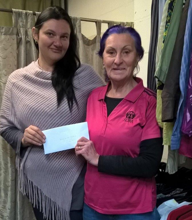 ADRA volunteer presents Melissa Cook of Riding for the Disable, with a donation from ADRA